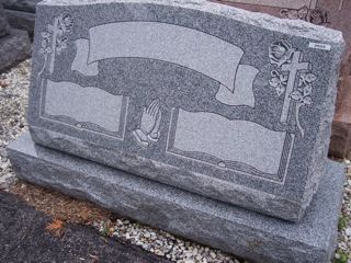 Gray granite double monument with crosses and hands