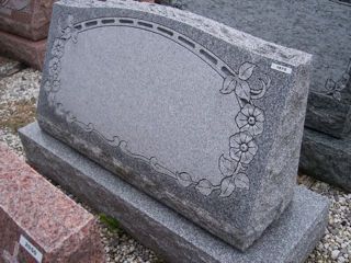 Gray granite monument with flowers