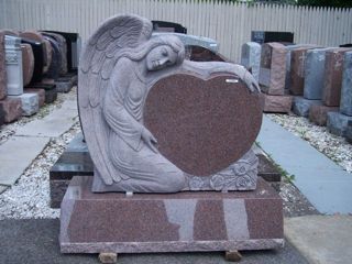 Granite Rose monument  with angel embracing heart