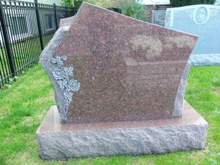 Granite Rose monument with flowers by Lutz Monument Company