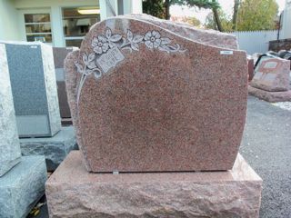 Granite Rose monument with flowers