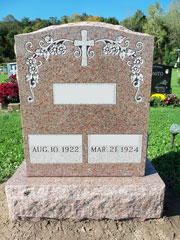 Double Granite Rose monument with flowers along top and corners and single cross