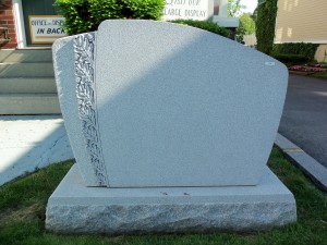 Gray granite monument with leaves at Karl Lutz Monument Company
