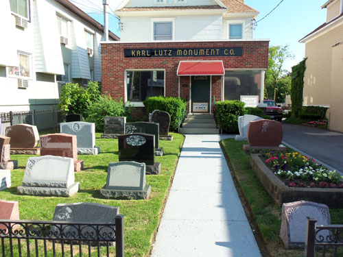 Street view of Karl Lutz Monument Company showing building and markers and monuments in front